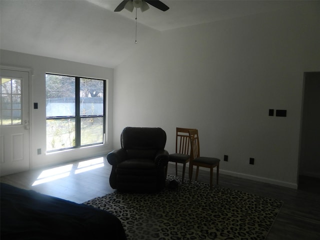 sitting room featuring ceiling fan, baseboards, vaulted ceiling, and wood finished floors