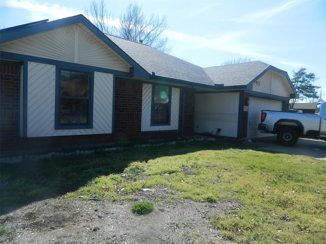 single story home with an attached garage, a shingled roof, a front yard, and brick siding