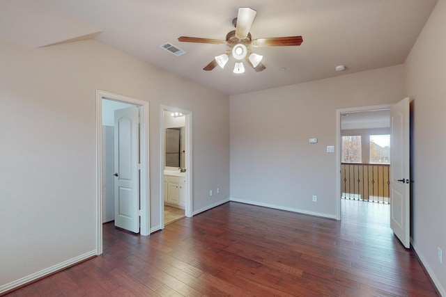 empty room featuring dark wood-type flooring and ceiling fan