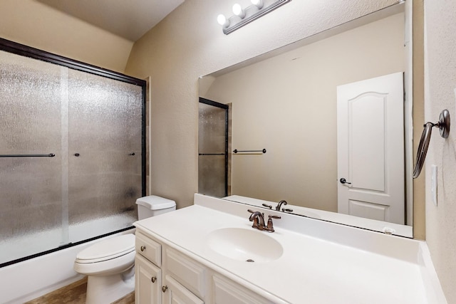 full bathroom featuring vanity, toilet, and combined bath / shower with glass door