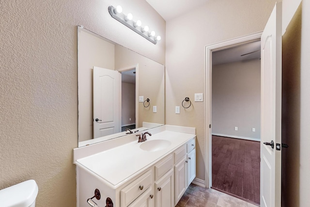 bathroom featuring hardwood / wood-style flooring, vanity, and toilet