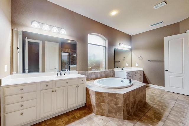 bathroom with independent shower and bath, vanity, and tile patterned floors