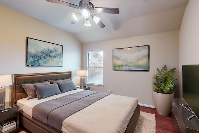 bedroom with lofted ceiling, dark hardwood / wood-style flooring, and ceiling fan