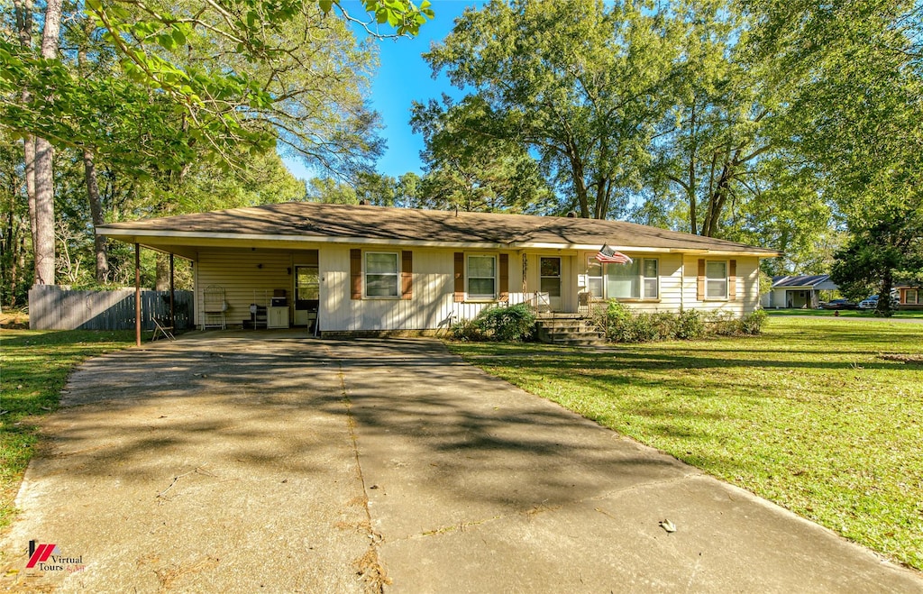 single story home featuring a front lawn and a carport