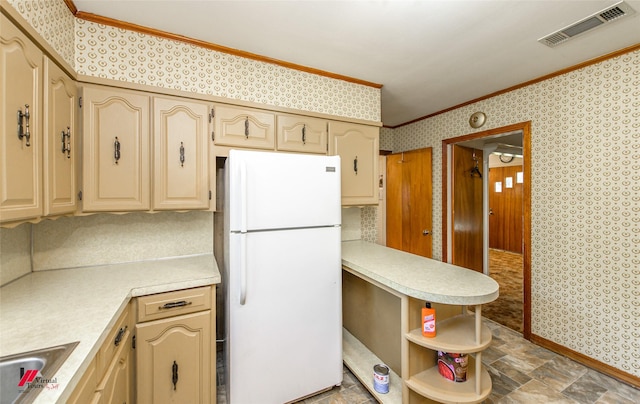 kitchen featuring crown molding, light brown cabinetry, sink, and white fridge