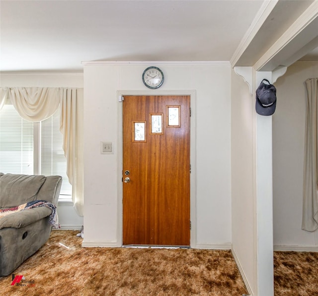 entryway featuring crown molding and carpet floors