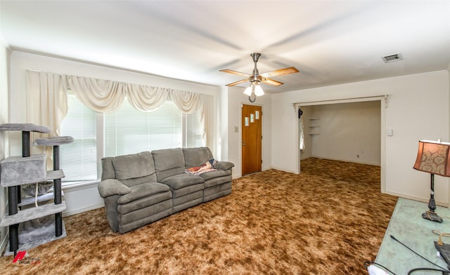 carpeted living room with ceiling fan