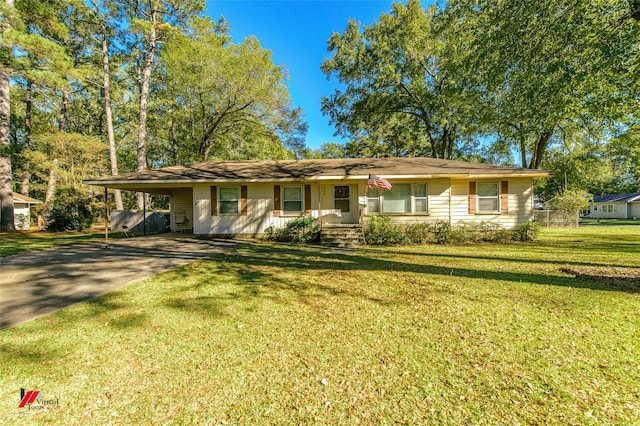 ranch-style house featuring a carport and a front lawn