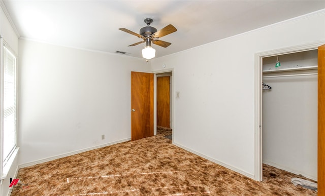 unfurnished bedroom with multiple windows, crown molding, carpet floors, and a closet