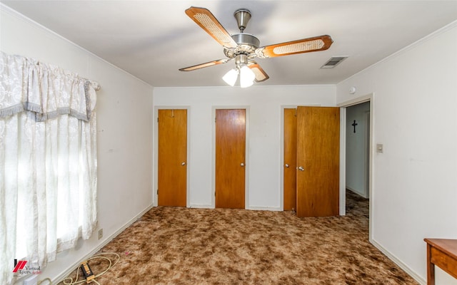 unfurnished bedroom with crown molding, carpet floors, and ceiling fan