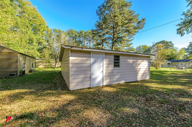 view of outbuilding with a yard