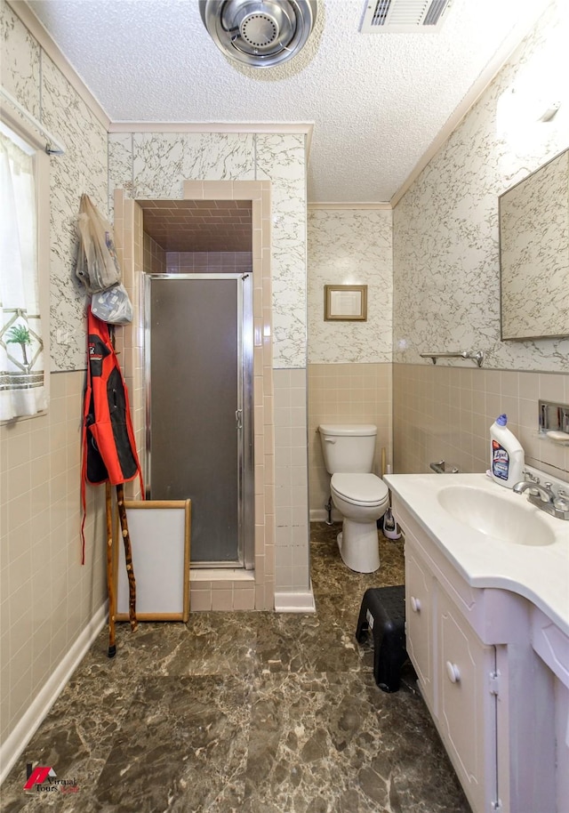 bathroom featuring crown molding, a shower with door, and a textured ceiling