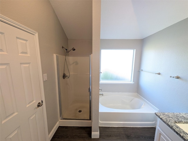 bathroom featuring vanity, hardwood / wood-style flooring, and independent shower and bath