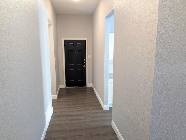 hallway with dark hardwood / wood-style flooring