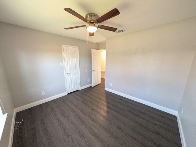 unfurnished bedroom featuring ceiling fan and dark wood-type flooring