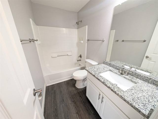 full bathroom with hardwood / wood-style flooring, vanity, toilet, and tub / shower combination