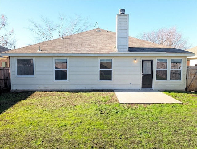 back of house featuring a patio area and a lawn