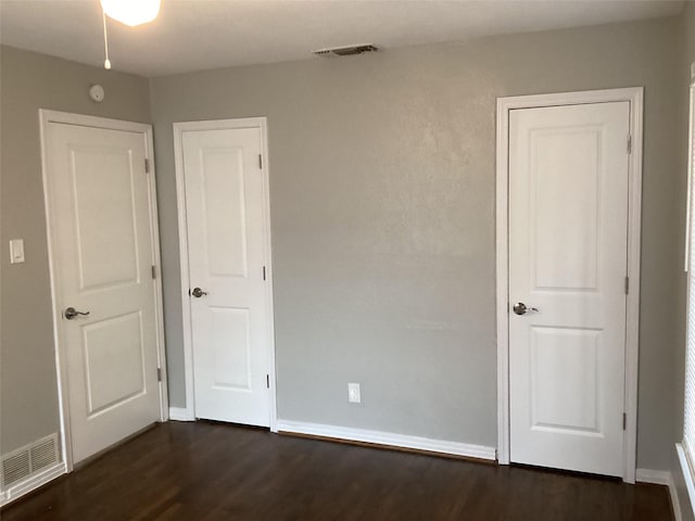 unfurnished bedroom featuring dark hardwood / wood-style floors