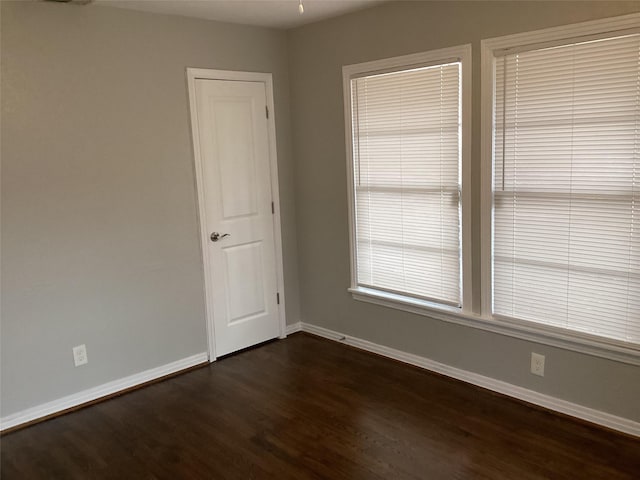 empty room with dark hardwood / wood-style floors