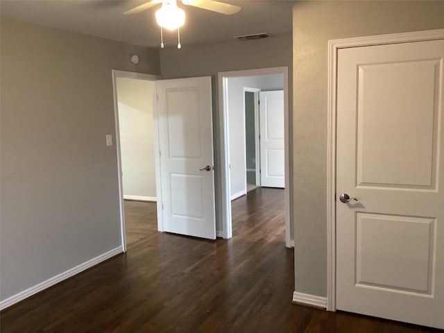 interior space featuring ceiling fan and dark wood-type flooring