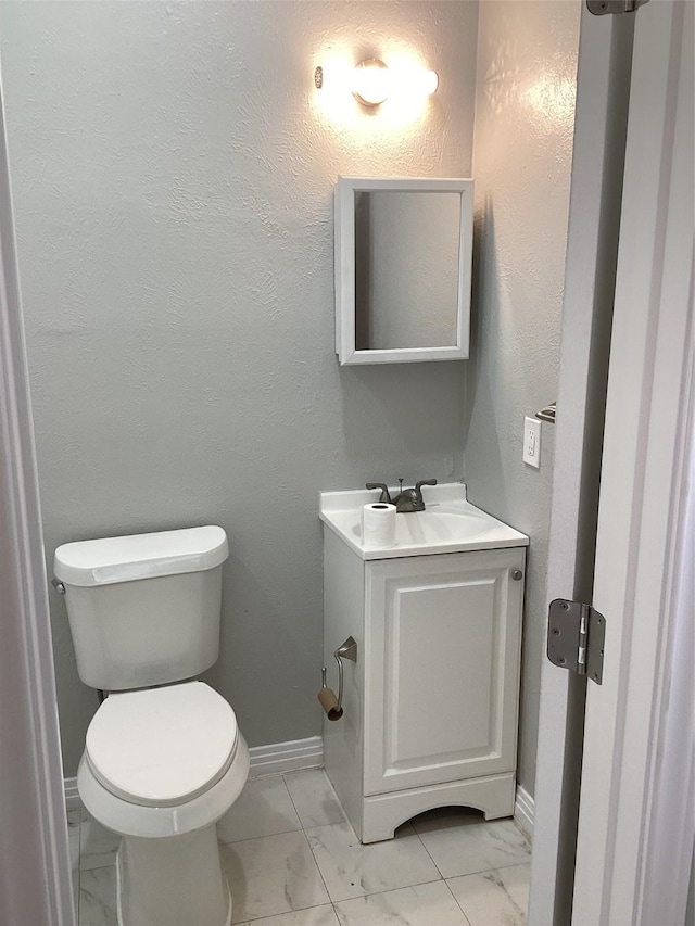 bathroom with toilet and vanity