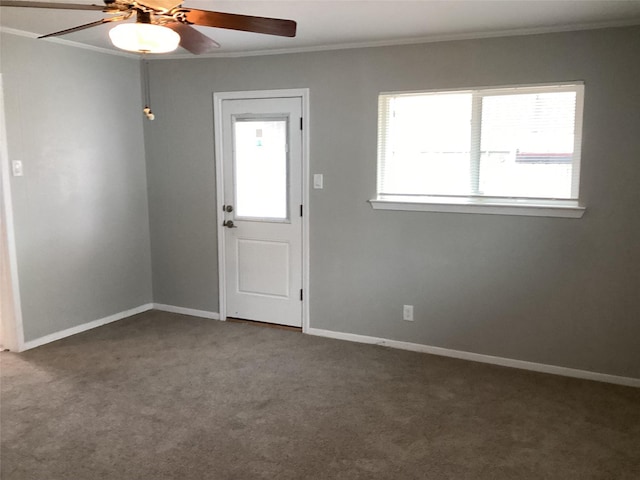 carpeted empty room with ceiling fan and crown molding