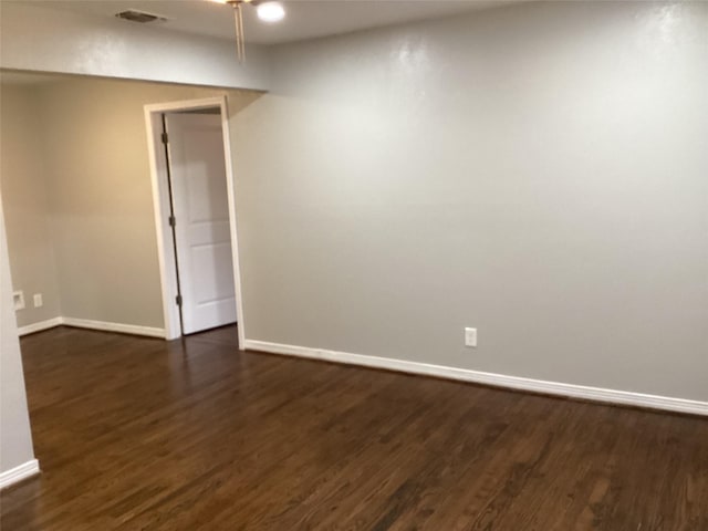 empty room featuring dark wood-type flooring