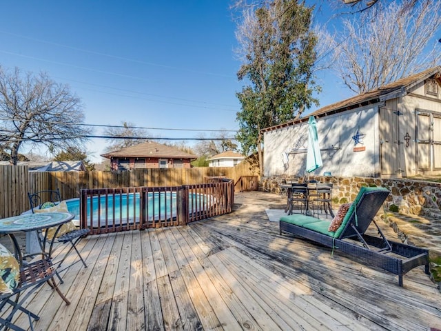 wooden terrace featuring a fenced in pool