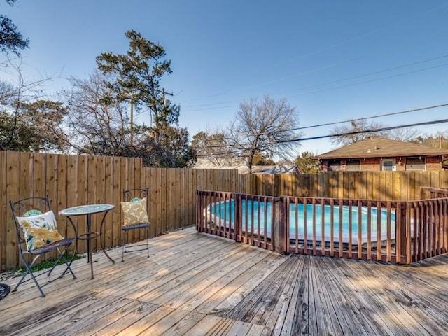 deck featuring a fenced in pool