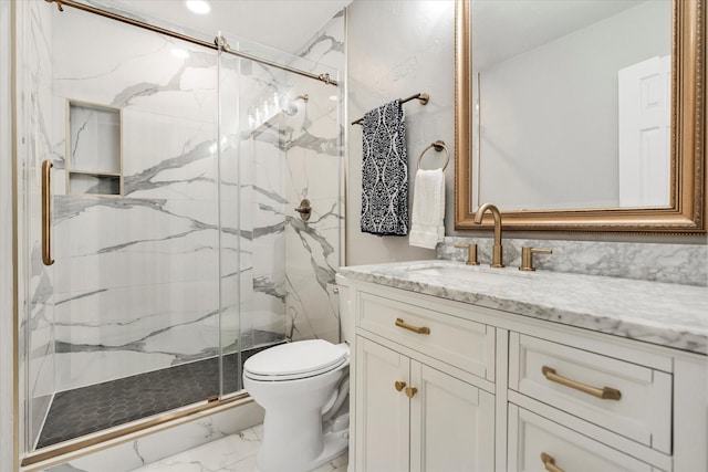 bathroom featuring vanity, a shower with door, and toilet