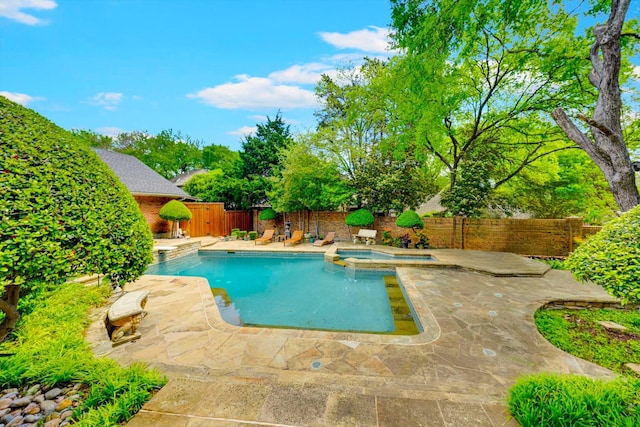 view of pool with an in ground hot tub and a patio