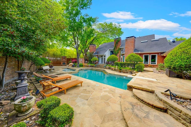 view of pool with an in ground hot tub and a patio area