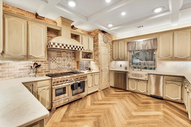 kitchen with sink, appliances with stainless steel finishes, custom range hood, decorative backsplash, and light parquet flooring