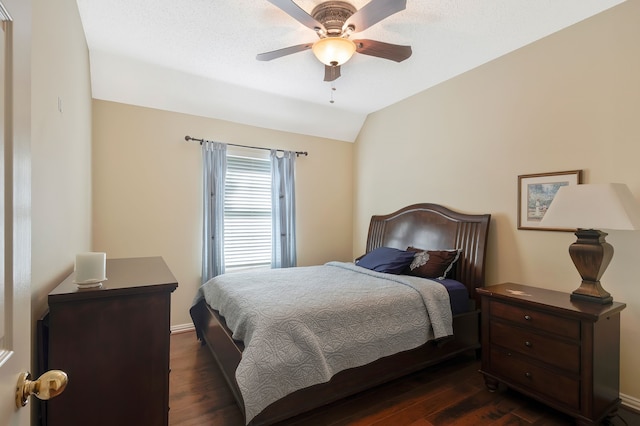 bedroom with lofted ceiling, dark wood-type flooring, and ceiling fan