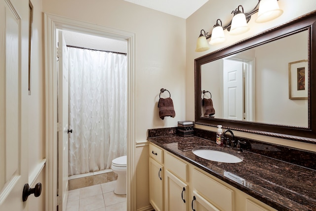 bathroom with walk in shower, tile patterned floors, vanity, and toilet