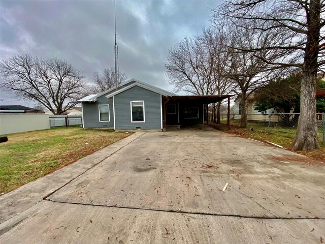 view of front of property with a front yard and a carport