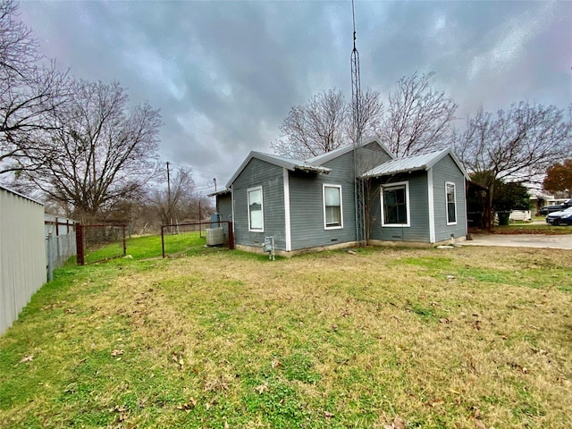 view of side of home with a yard