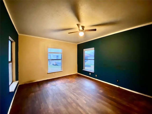 spare room featuring hardwood / wood-style flooring, ornamental molding, ceiling fan, and a textured ceiling