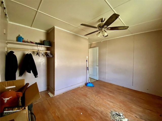 interior space with hardwood / wood-style floors, a paneled ceiling, and ceiling fan