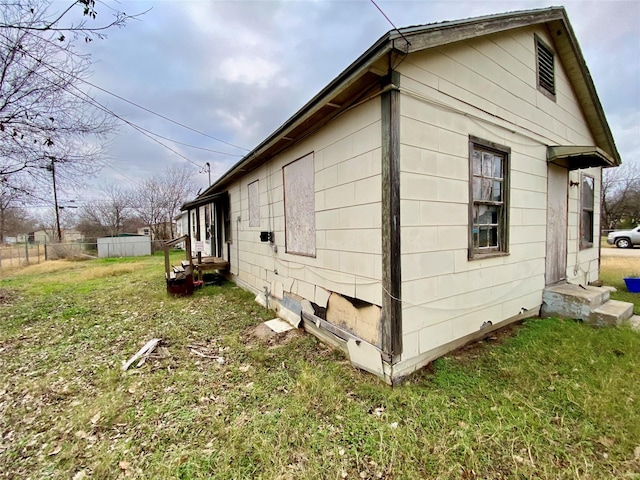 view of side of property featuring a yard