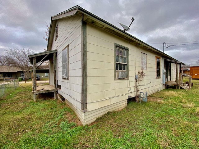 view of side of property with a yard