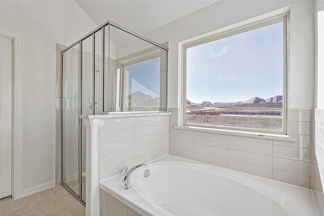 bathroom with separate shower and tub and tile patterned floors