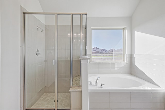 bathroom featuring shower with separate bathtub