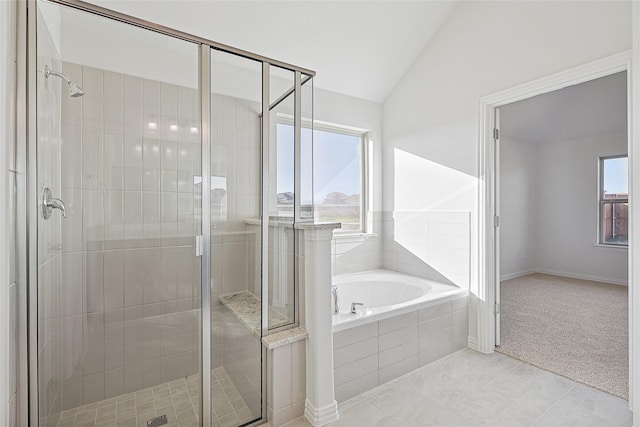 bathroom with vaulted ceiling, tile patterned floors, and plus walk in shower