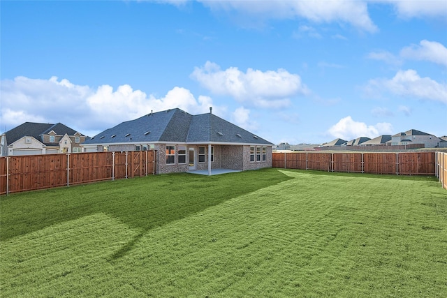 rear view of property featuring a patio area and a lawn