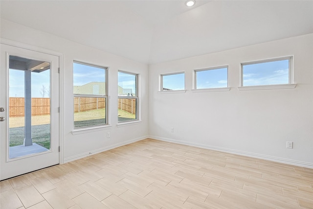 unfurnished sunroom featuring lofted ceiling