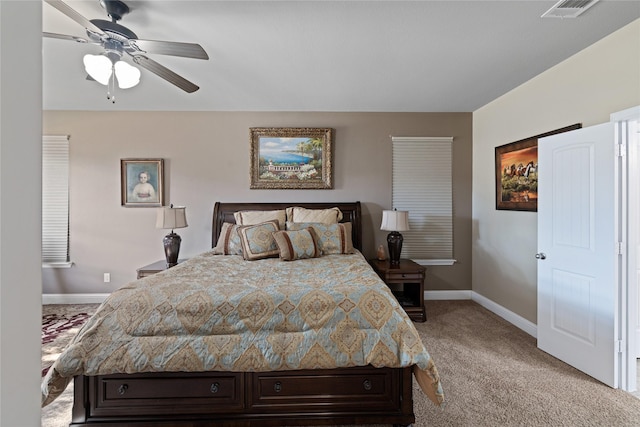 bedroom with ceiling fan and light carpet