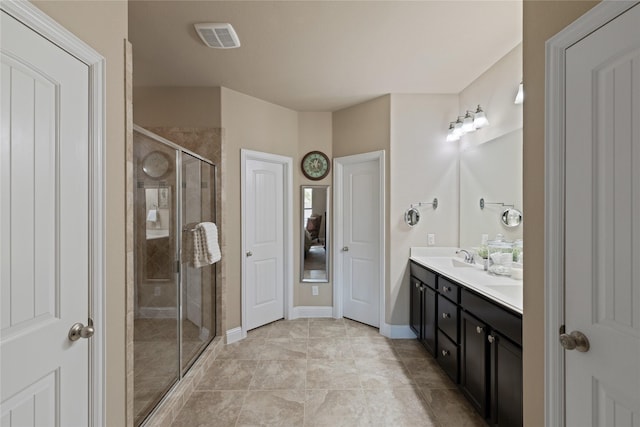 bathroom featuring tile patterned flooring, vanity, and a shower with door