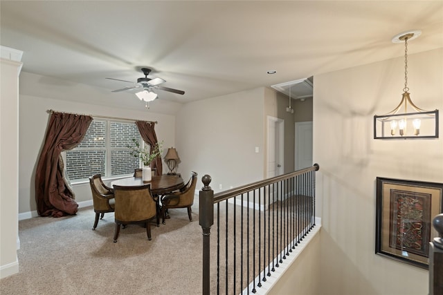 carpeted dining space with ceiling fan