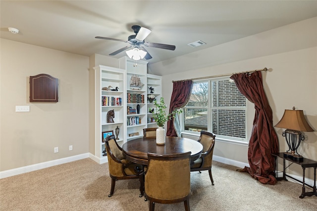 dining area with light colored carpet and ceiling fan